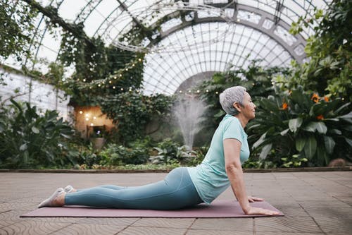 life insurance, image of senior woman doing upward dog yoga pose