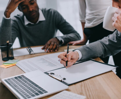 Professionals reviewing and signing legal documents during an estate planning meeting, illustrating why estate planning is important for protecting assets and making informed decisions.