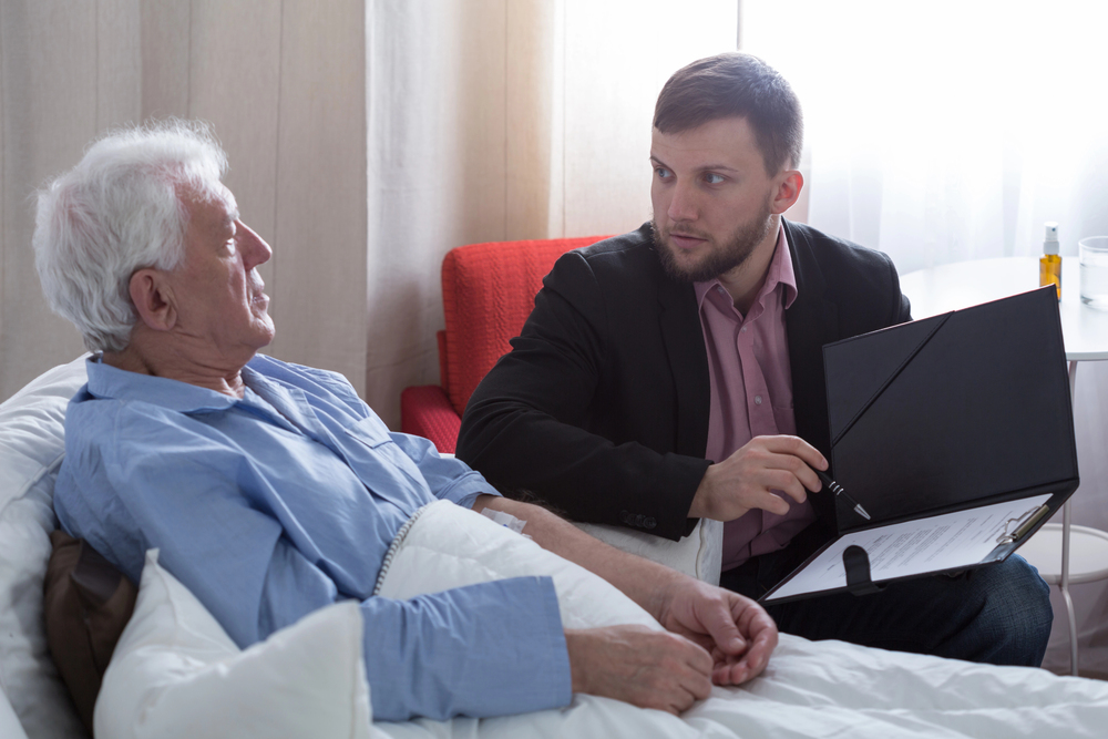 estate planning attorney meeting with an elderly client to discuss probate and end-of-life legal decisions