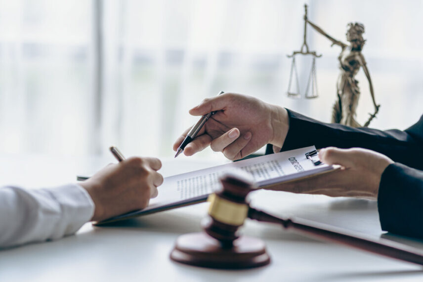 client meeting with attorney reviewing documents, related to estate planning and trust management