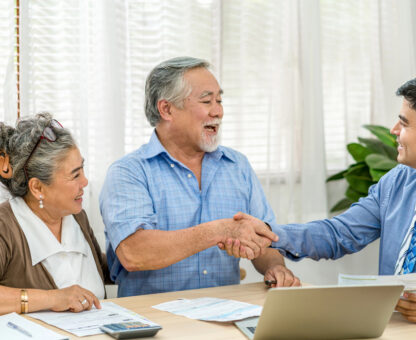 elder couple talking with estate planning attorney