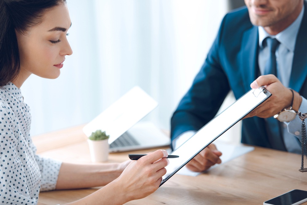 woman looking at document who demonstrates benefits of revocable trust married vs single