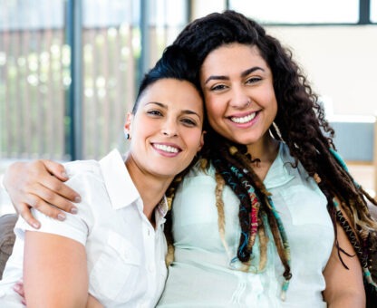 gay couple smiling and embracing each other