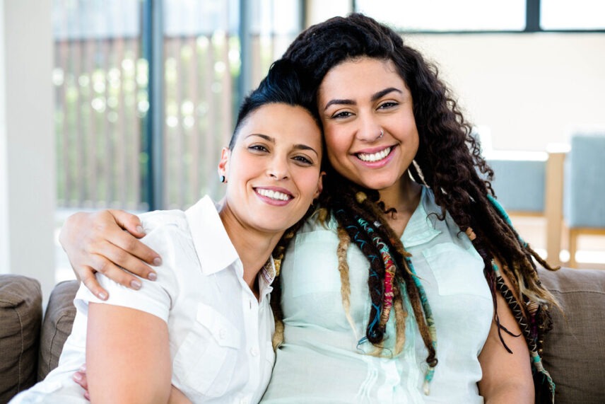gay couple smiling and embracing each other